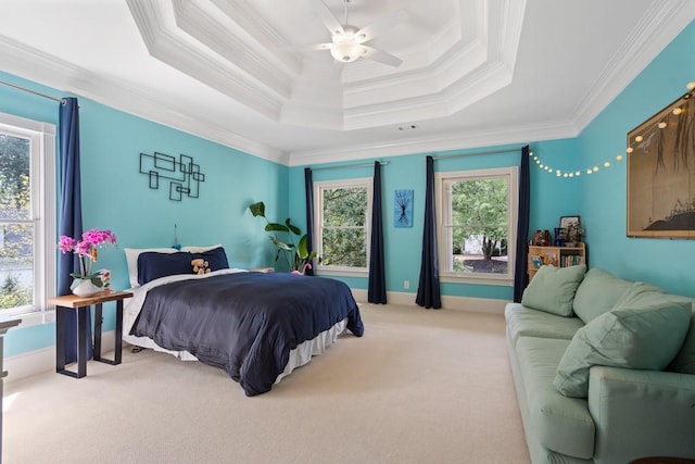 bedroom featuring ornamental molding, carpet, ceiling fan, and a raised ceiling