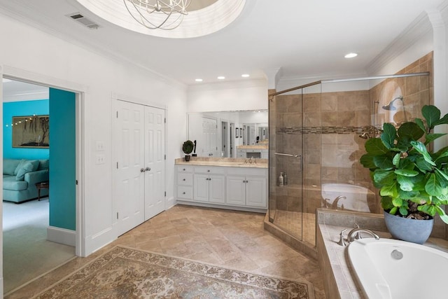 bathroom featuring plus walk in shower, vanity, and crown molding