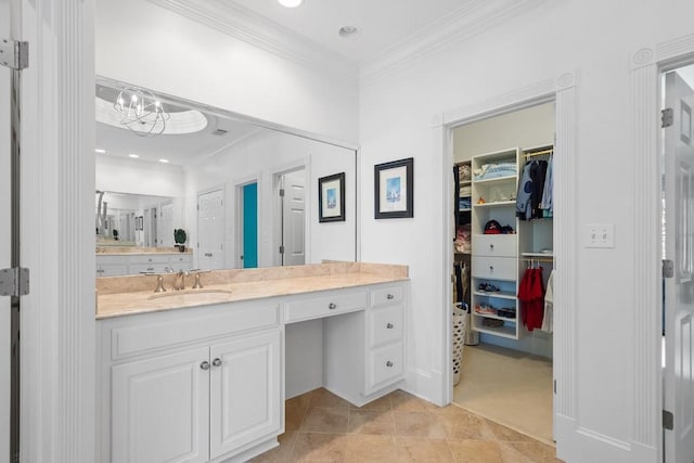 bathroom with ornamental molding, a chandelier, tile patterned flooring, and vanity