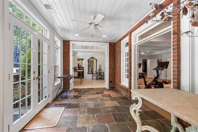 sunroom with ceiling fan, french doors, and wooden ceiling