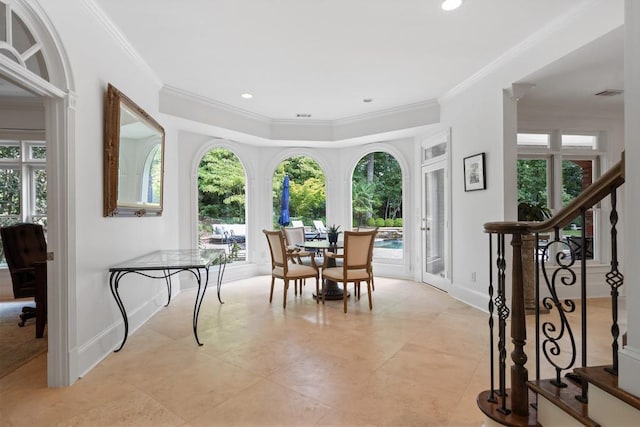 tiled dining room featuring crown molding and a healthy amount of sunlight