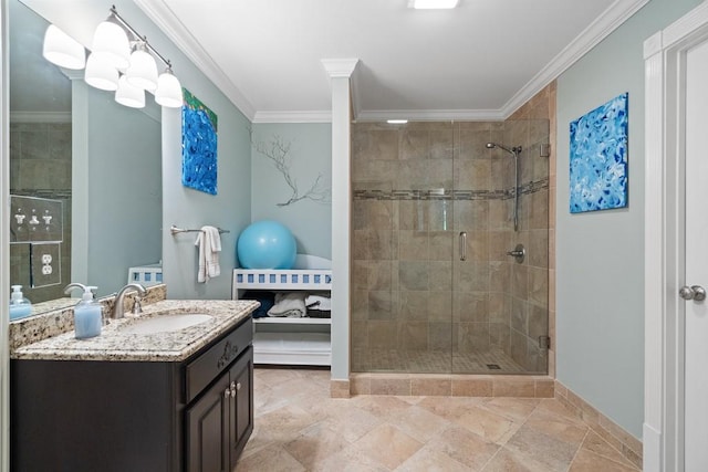 bathroom with ornamental molding, vanity, and a shower with door