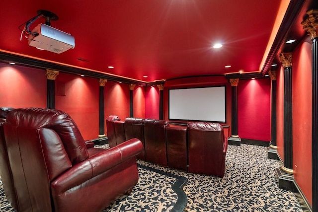 carpeted home theater room featuring ornamental molding