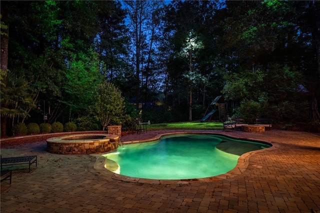 view of swimming pool with an in ground hot tub and a patio