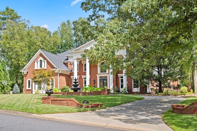 greek revival inspired property featuring a front yard