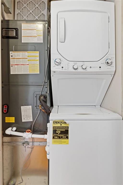 clothes washing area featuring stacked washer and dryer