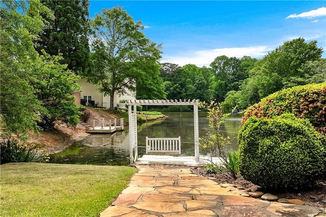 view of yard with a water view and a dock