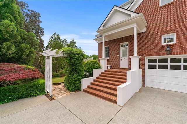 exterior space with concrete driveway and brick siding