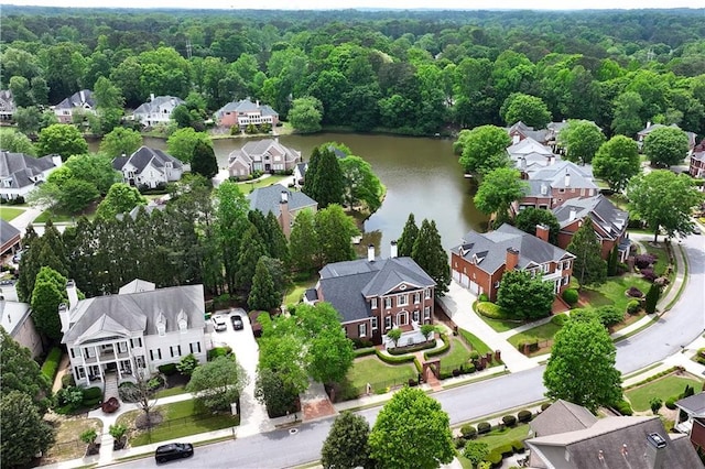 birds eye view of property with a water view, a residential view, and a forest view