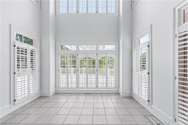 interior space with french doors, visible vents, and a wealth of natural light