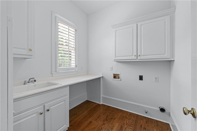 washroom featuring dark wood-style flooring, hookup for a washing machine, electric dryer hookup, a sink, and cabinet space