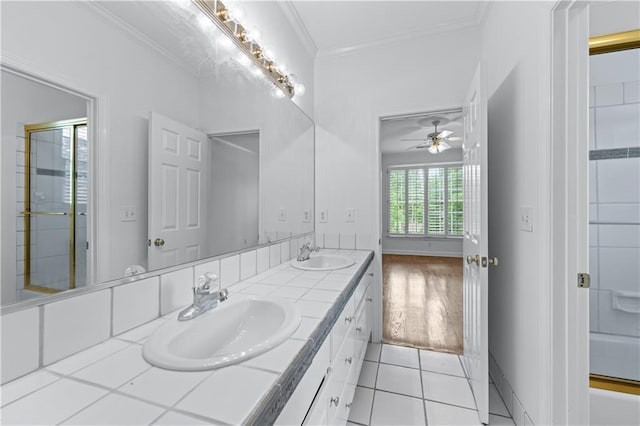 bathroom with a sink, tile patterned flooring, ornamental molding, and ceiling fan
