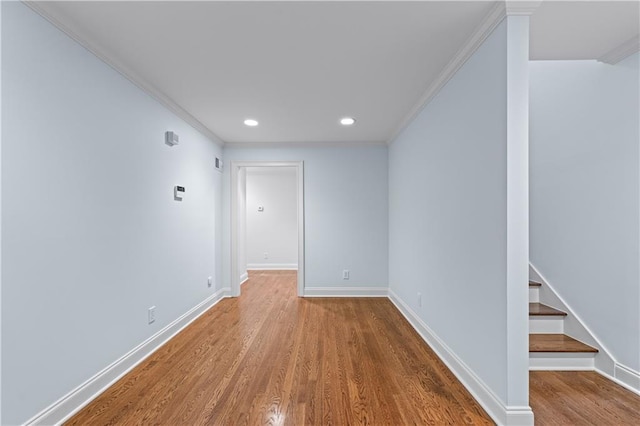 interior space featuring crown molding, recessed lighting, baseboards, and wood finished floors