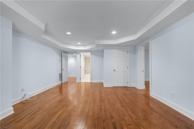 below grade area with baseboards, ornamental molding, and wood finished floors