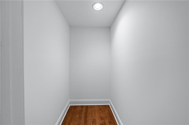 interior space featuring baseboards and dark wood-type flooring