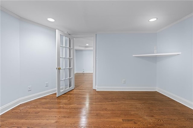 basement featuring baseboards, ornamental molding, wood finished floors, and recessed lighting