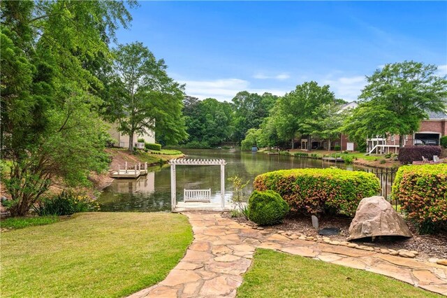 view of yard featuring a water view and a pergola