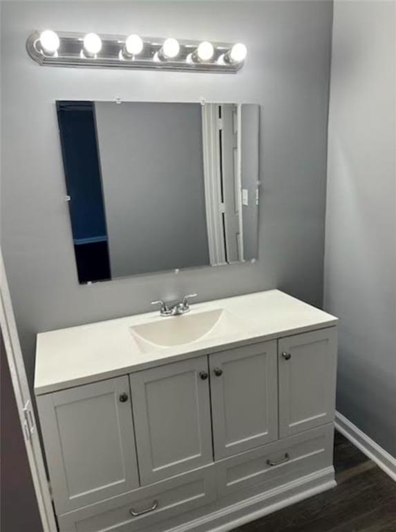 bathroom with vanity and hardwood / wood-style flooring