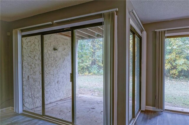 entryway featuring hardwood / wood-style floors and a textured ceiling