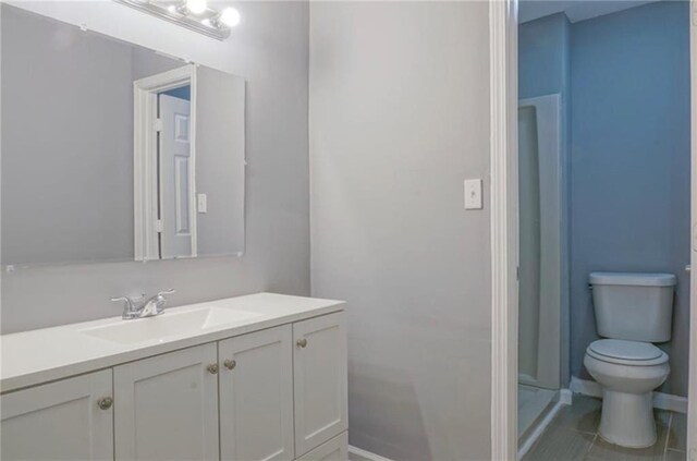 bathroom with tile patterned floors, vanity, and toilet