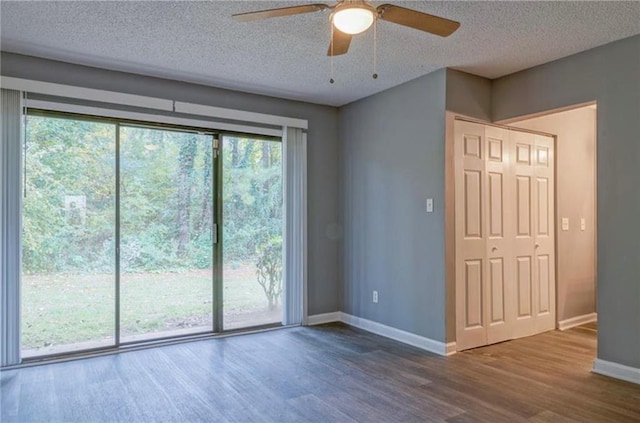 unfurnished room featuring hardwood / wood-style floors, a textured ceiling, and ceiling fan