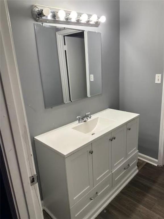 bathroom with hardwood / wood-style floors and vanity