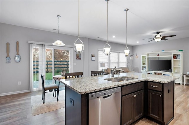 kitchen featuring dishwasher, sink, pendant lighting, a kitchen island with sink, and dark brown cabinets