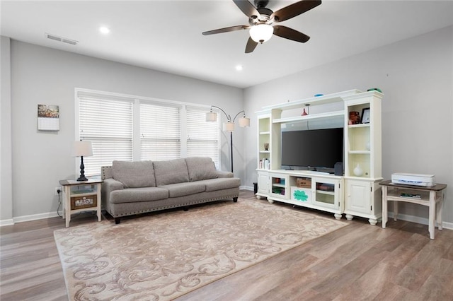 living room with ceiling fan and light hardwood / wood-style floors