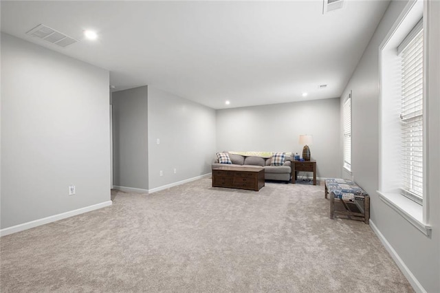 living room featuring light carpet and a wealth of natural light