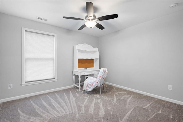 interior space featuring ceiling fan and carpet