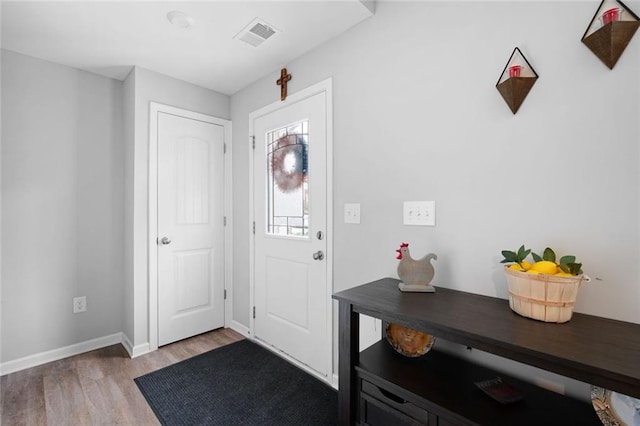 foyer entrance with light hardwood / wood-style floors