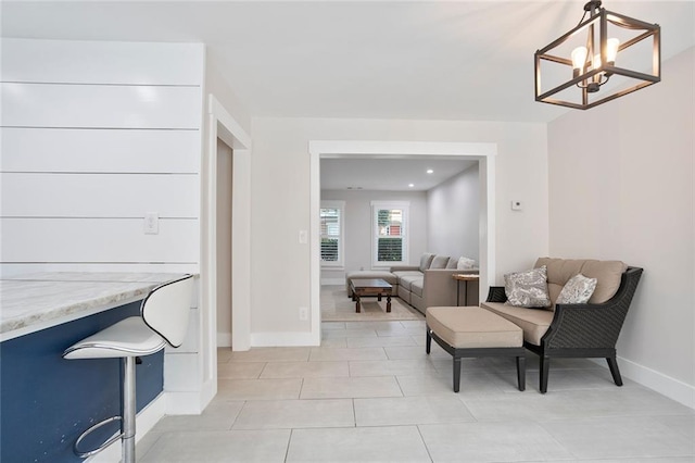 4167 Oakwood Way, Duluth, GA 30096 - living area with baseboards, light tile patterned floors, and a chandelier