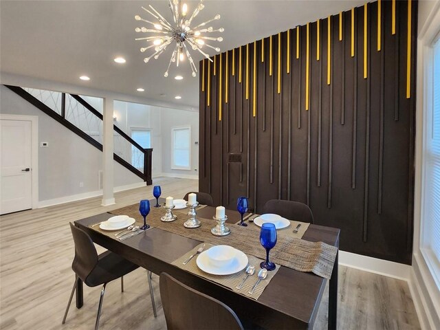 dining room with a chandelier and light wood-type flooring