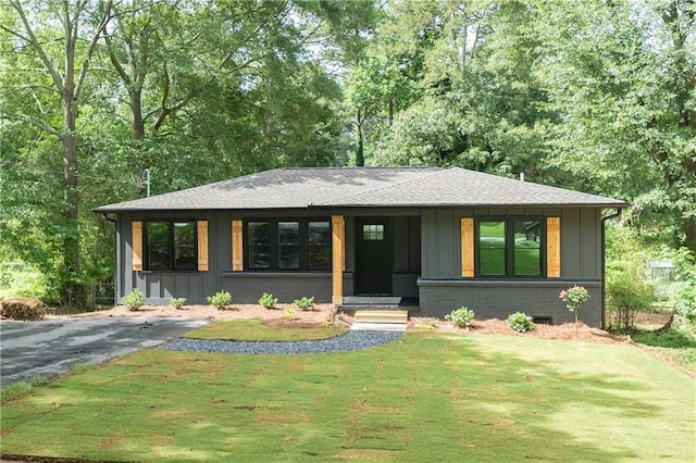 45 Driskell Ave, Mableton, GA 30126 - view of front of property with board and batten siding, a front yard, roof with shingles, and brick siding