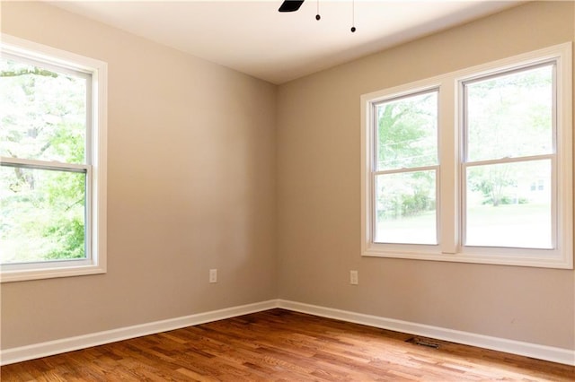 45 Driskell Ave, Mableton, GA 30126 - empty room featuring healthy amount of natural light, wood finished floors, and a ceiling fan