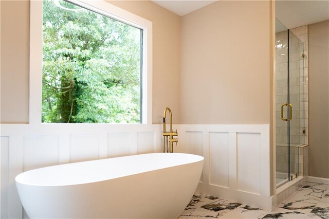 45 Driskell Ave, Mableton, GA 30126 - full bath featuring a decorative wall, marble finish flooring, a soaking tub, a stall shower, and healthy amount of natural light