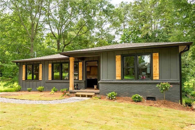 45 Driskell Ave, Mableton, GA 30126 - view of front facade with board and batten siding, a front lawn, and crawl space