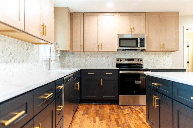 45 Driskell Ave, Mableton, GA 30126 - kitchen with appliances with stainless steel finishes, light countertops, light wood finished floors, tasteful backsplash, and recessed lighting