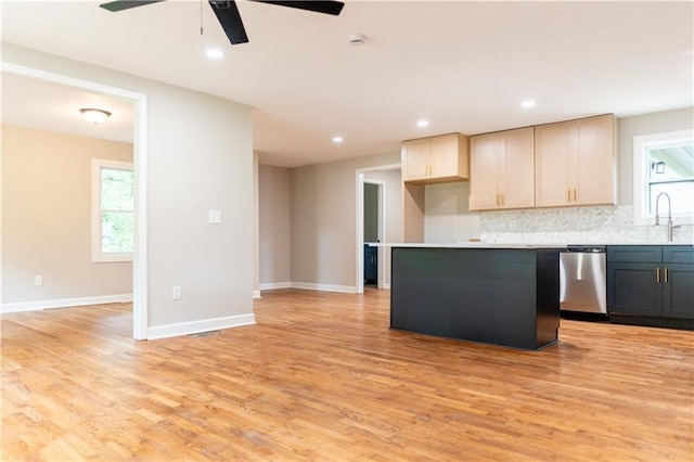 45 Driskell Ave, Mableton, GA 30126 - kitchen with stainless steel dishwasher, a ceiling fan, backsplash, a center island, and light wood-style floors