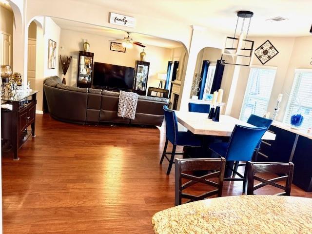 558 Hideaway Dr, Jonesboro, GA 30238 - dining area featuring arched walkways and dark wood-style flooring
