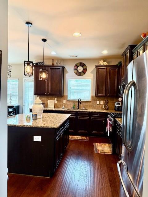 558 Hideaway Dr, Jonesboro, GA 30238 - kitchen with stainless steel appliances, dark wood finished floors, light stone counters, and dark brown cabinetry