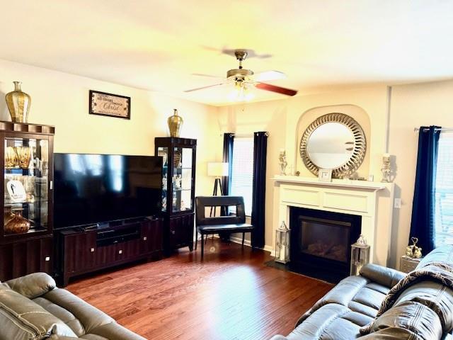 558 Hideaway Dr, Jonesboro, GA 30238 - living area featuring a ceiling fan, wood finished floors, and a fireplace with flush hearth