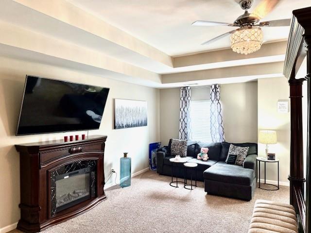 558 Hideaway Dr, Jonesboro, GA 30238 - carpeted living area with baseboards, ceiling fan, and a tray ceiling