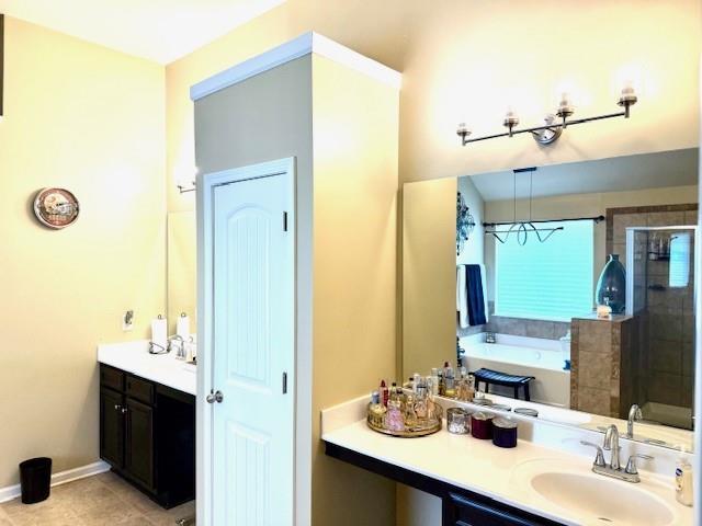 558 Hideaway Dr, Jonesboro, GA 30238 - bathroom featuring vanity, a shower stall, a bath, tile patterned flooring, and baseboards