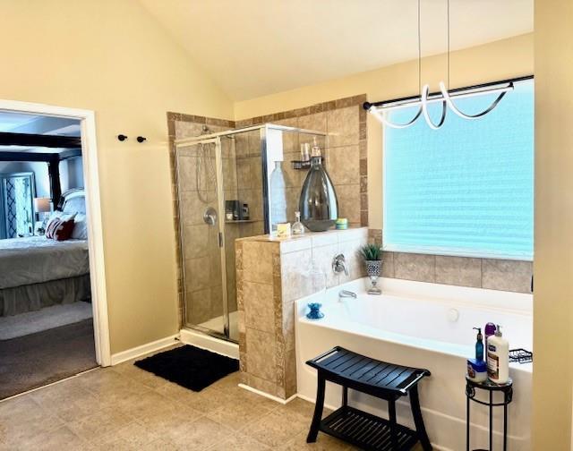 558 Hideaway Dr, Jonesboro, GA 30238 - ensuite bathroom with a bath, a stall shower, vaulted ceiling, and tile patterned flooring
