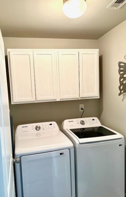 558 Hideaway Dr, Jonesboro, GA 30238 - laundry area with cabinet space and washer and clothes dryer