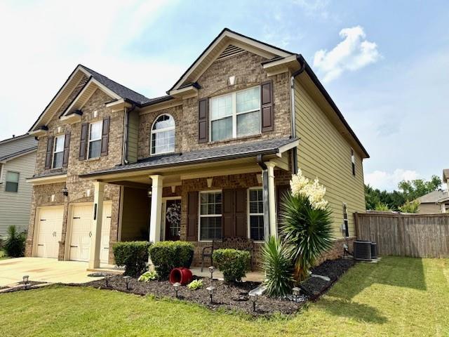 558 Hideaway Dr, Jonesboro, GA 30238 - view of front facade with a porch, an attached garage, driveway, cooling unit, and stone siding