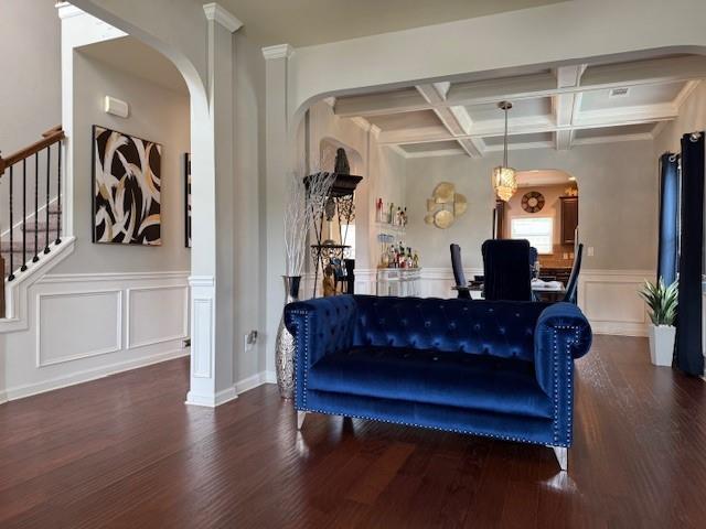 558 Hideaway Dr, Jonesboro, GA 30238 - living room featuring arched walkways, wood finished floors, coffered ceiling, beam ceiling, and a decorative wall