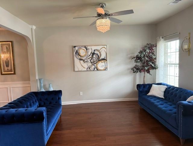 558 Hideaway Dr, Jonesboro, GA 30238 - living room with wood finished floors, a ceiling fan, arched walkways, and baseboards