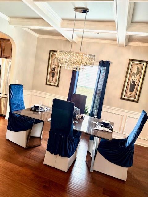 558 Hideaway Dr, Jonesboro, GA 30238 - dining space with coffered ceiling, a chandelier, arched walkways, beam ceiling, and wood finished floors